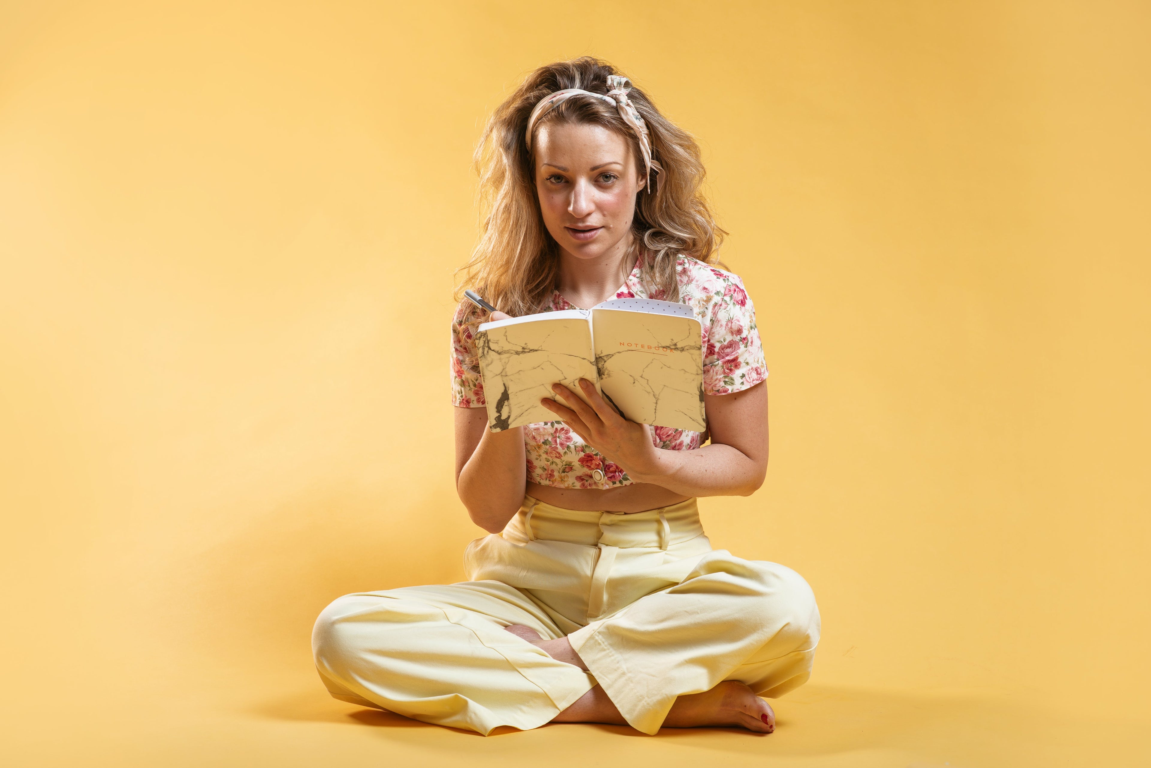 spring-fashion-model-sitting-and-writing-in-notebook